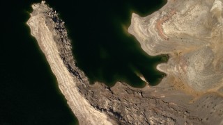 FG0001_000274 - 4K aerial stock footage of a bird's eye view of the shore and green water of Lake Mead
