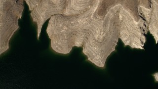 FG0001_000275 - 4K aerial stock footage of a bird's eye view of the green water of Lake Mead, and reveal the desert shore