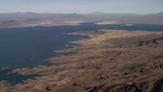 FG0001_000278 - 4K aerial stock footage of a view across Lake Mead seen from the barren desert shore