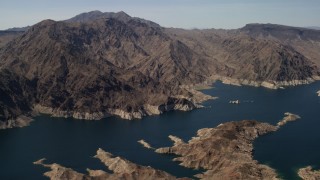 FG0001_000295 - 4K aerial stock footage of tall desert mountains on the shore of Lake Mead, Nevada