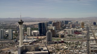 FG0001_000319 - 4K aerial stock footage pass by Stratosphere, with a view of hotels and casinos on the Las Vegas Strip in Nevada