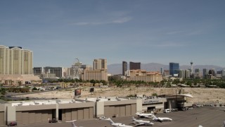 FG0001_000333 - 4K aerial stock footage of lifting off from McCarran Airport to focus on casino resorts on the Las Vegas Strip, Nevada