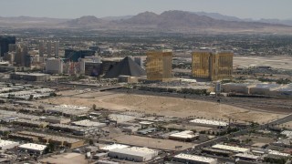 FG0001_000353 - 4K aerial stock footage of Vegas Strip casino resorts across I-15 from an open dirt lot in Las Vegas, Nevada