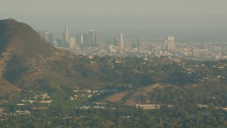 HDA06_02 - HD stock footage aerial video Downtown Los Angeles skyline, seen from the Hollywood Hills in California at sunset