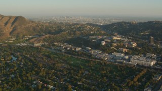 HDA06_04 - HD stock footage aerial video Universal Studios Hollywood and Downtown Los Angeles skyline, Universal City, California, sunset