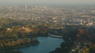 HDA06_07 - HD stock footage aerial video Downtown Los Angeles skyline at sunset seen from the Mulholland Dam in the Hollywood Hills, California