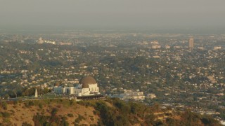 HDA06_08 - HD stock footage aerial video flyby Griffith Observatory overlooking the LA Basin at sunset, Hollywood Hills, California