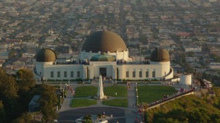 HDA06_10 - HD stock footage aerial video orbit the Griffith Observatory at sunset with tourists, California