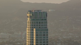 HDA06_23 - HD stock footage aerial video view of Griffith Observatory, reveal and orbit US Bank Tower in Downtown Los Angeles, California at sunset