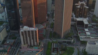 HDA06_31 - HD stock footage aerial video tilt and follow S Hope Street at sunset in Downtown Los Angeles, California