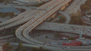 HDA06_35 - HD stock footage aerial video interchange between the 110 and 10 freeways at sunset in Downtown Los Angeles, California