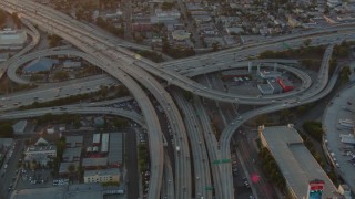 HDA06_36 - HD stock footage aerial video the interchange of 110 and 10 with light traffic at sunset in Downtown Los Angeles, California