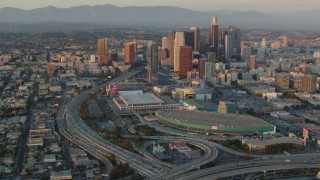 HDA06_37 - HD stock footage aerial video the 110 and 10 freeway interchange, LA Convention Center, and Downtown Los Angeles, California at sunset