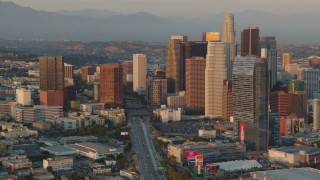 HDA06_38 - HD stock footage aerial video Downtown Los Angeles skyscrapers and the 110 freeway at sunset, California