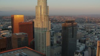 HDA06_42 - HD stock footage aerial video approach US Bank Tower and Gas Company Tower at sunset in Downtown Los Angeles, California