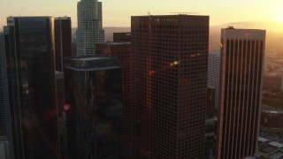 HDA06_43 - HD stock footage aerial video orbit a group of skyscrapers at sunset in Downtown Los Angeles, California