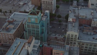 HDA06_48 - HD stock footage aerial video orbit Eastern Columbia Building condo complex at sunset in Downtown Los Angeles, California