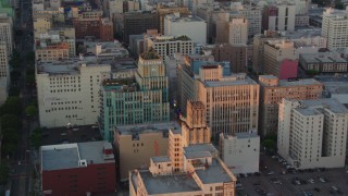HDA06_51 - HD stock footage aerial video flyby Eastern Columbia Building and Orpheum Theater to reveal Broadway at sunset, Downtown Los Angeles, California