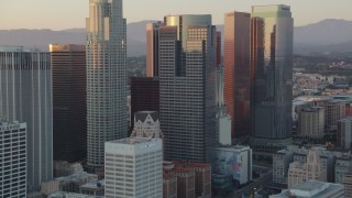 HDA06_52 - HD stock footage aerial video tilt from Eastern Columbia Building to reveal and approach skyscrapers in Downtown Los Angeles, California at sunset