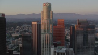 HDA06_53 - HD stock footage aerial video orbit US Bank Tower to reveal top of Aon Center at sunset, Downtown Los Angeles, California