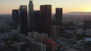 HDA06_56 - HD stock footage aerial video approach the Downtown Los Angeles skyline at sunset, California