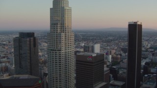 HDA06_57 - HD stock footage aerial video flyby top of Bank of America Center, focus on US Bank Tower at twilight, Downtown Los Angeles, California