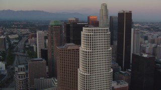 HDA06_60 - HD stock footage aerial video flyby 777 Tower and skyscrapers near US Bank Tower at twilight in Downtown Los Angeles, California