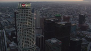 HDA06_62 - HD stock footage aerial video orbit top of US Bank Tower to reveal other skyscrapers in Downtown Los Angeles, California at twilight
