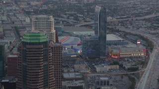 HDA06_63 - HD stock footage aerial video flyby skyscrapers in Downtown Los Angeles at twilight to reveal Staples Center and Ritz-Carlton in California