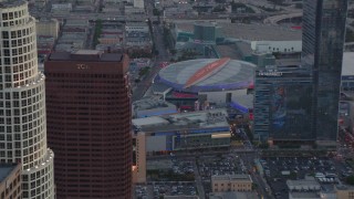 HDA06_64 - HD stock footage aerial video fly over skyscrapers to approach Staples Center and Nokia Theater at sunset, Downtown Los Angeles, California