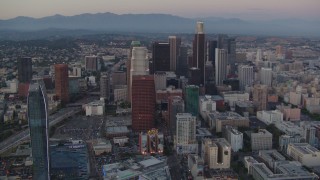 HDA06_66 - HD stock footage aerial video tilt from Staples Center and Nokia Theater to reveal Downtown Los Angeles, California, twilight