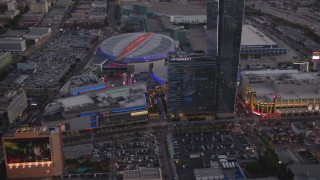 HDA06_77 - HD stock footage aerial video approach Nokia Theater, Staples Center and hotels in Downtown Los Angeles, California, twilight