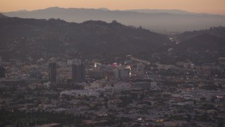 HDA06_80 - HD stock footage aerial video approach office buildings and Capitol Records at twilight in Hollywood, California