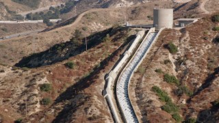 HDA07_09 - HD stock footage aerial video of approaching the top of the Los Angeles Aqueduct; San Fernando Valley, California