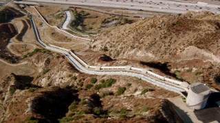 HDA07_11 - HD stock footage aerial video flying over the Los Angeles Aqueduct to reveal I-5, San Fernando Valley, California