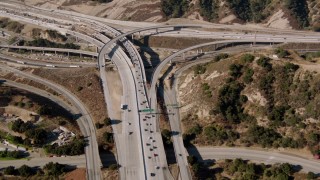 HDA07_14 - HD aerial stock footage video of a reverse view of Newhall Pass, Santa Clarita, California