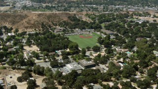 HDA07_25 - HD aerial stock footage video of fly over homes to baseball field, Newhall, California