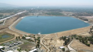 HDA07_34 - HD stock footage aerial video approach and fly over the Los Angeles Reservoir, Granada Hills, California