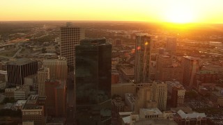 HDA12_007 - HD stock footage aerial video flyby skyscrapers with setting sun in distance in Downtown Fort Worth, Texas