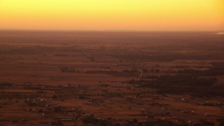 HDA12_024 - HD stock footage aerial video of flying by farmland and rural homes at sunrise, Decatur, Texas