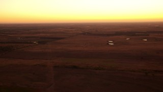 HDA12_027 - HD stock footage aerial video pass rural homes and farm fields at sunrise in Decatur, Texas