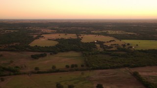 HDA12_032 - HD stock footage aerial video of wide view of farm fields at sunrise in Decatur, Texas