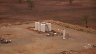 HDA12_036 - HD stock footage aerial video of small farm silos at sunrise in Decatur, Texas