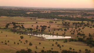 HDA12_037 - HD stock footage aerial video of a pond, rural homes and farms at sunrise, Decatur, Texas