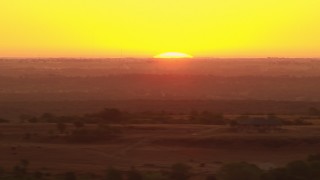 HDA12_039 - HD stock footage aerial video of the rising sun behind farm fields in Decatur, Texas