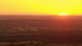 HDA12_040 - HD stock footage aerial video pan from farmland to reveal rising sun in Decatur, Texas