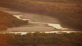 HDA12_054 - HD stock footage aerial video of flying by Red River at sunrise, Texas