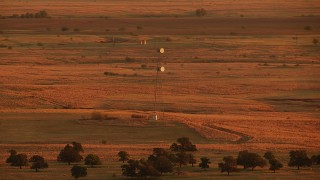 HDA12_056 - HD stock footage aerial video of a tower on farmland at sunrise in Oklahoma