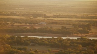HDA12_066 - HD stock footage aerial video of a barn and farmland at sunrise near Comanche Lake, Oklahoma