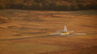 HDA12_068 - HD stock footage aerial video of a building in the middle of a field at sunrise in Oklahoma